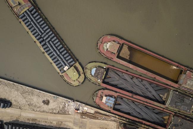 © Bloomberg. Ships loaded with steel rods and steel wire are moored at a depot in this aerial photograph taken on the outskirts of Shanghai, China. 