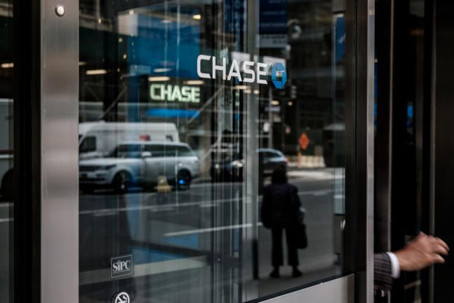 © Bloomberg. A customer exits a JPMorgan Chase & Co. bank branch in New York, U.S., on Wednesday, April 11, 2018. JPMorgan Chase & Co. is scheduled to release earnings figures on April 13. 