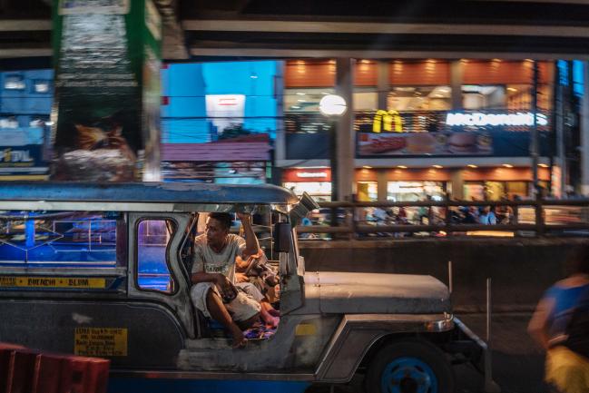 © Bloomberg. A jeepney travels along a road in Manila, Philippines. Photographer: Hannah Reyes Morales/Bloomberg