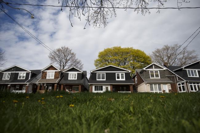 &copy Bloomberg. Houses stand in Toronto, Ontario, Canada, on Thursday, May 11, 2017. Toronto home prices climbed 5 percent in April, suggesting the Ontario government's foreign buyer tax and troubles at Home Capital Group Inc. haven't yet cooled the market. 
