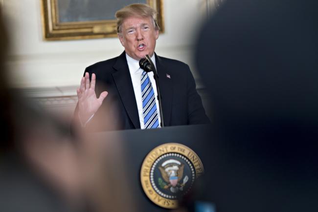 © Bloomberg. U.S. President Donald Trump speaks during a press conference about the Parkland, Florida high school shooting in the Diplomatic Room of the White House in Washington, D.C., U.S., on Thursday, Feb. 15, 2018. An orphaned 19-year-old with a troubled past and his own AR-15 rifle was charged with 17 counts of premeditated murder this morning following the deadliest school shooting in the U.S. in five years that occurred yesterday.