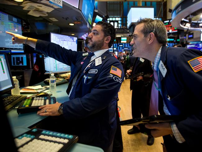 © Bloomberg. Traders work on the floor of the New York Stock Exchange. Photographer: Michael Nagle/Bloomberg