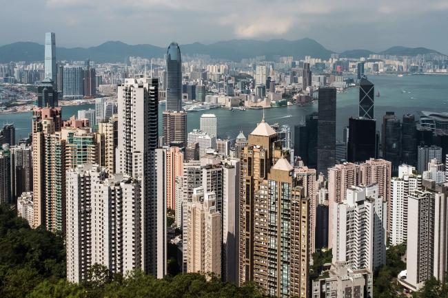 © Bloomberg. Residential and commercial buildings are seen from Victoria Peak in Hong Kong, China, on Monday, Sept. 11, 2017. Hong Kong stocks fluctuated on Sept. 12 as automakers extended gains driven by China\\'s plan to phase out fossil-fuel vehicles, while banks and property companies weighed on the benchmark index. Photographer: Billy H.C. Kwok/Bloomberg