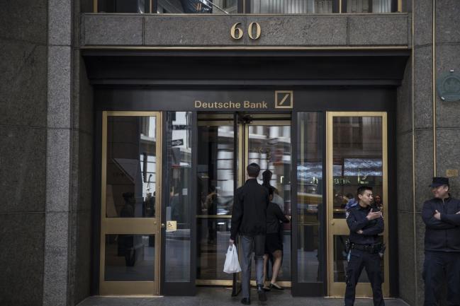 © Bloomberg. People enter Deutsche Bank AG headquarters on Wall Street in New York, U.S., on Thursday, April, 26, 2018. Deutsche Bank AG is planning to cut more than 10 percent of U.S. jobs as it withdraws from businesses where it can't compete, a person briefed on the matter said. 