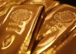 Цены на золото незначительно выросли после смешанных отчетов США