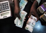 UPDATE 1-Nigeria naira hits record intra-day low of 429.75 per dollar
