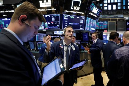 Wall Street dips but off earlier lows; Nasdaq flat