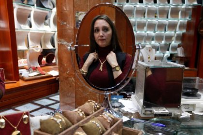 Rolexes and cars; Lebanese spend big to prise savings from the bank