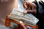 Dollar falls against commodity currencies but holds gains versus yen
