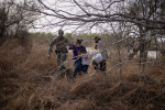 Capturing the moment a U.S. border patrol agent reaches out to a young migrant