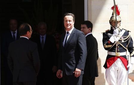 Britain's Prime Minister Cameron walks with French President Hollande before the official lunch at Benouville Castle