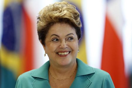 © Reuters. Brazil's President Rousseff smiles during a signing ceremony with Chile's President Bachelet at the Planalto Palace in Brasilia