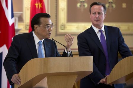 © Reuters. Britain's PM Cameron listens to Chinese Premier Li speak during a news conference in London