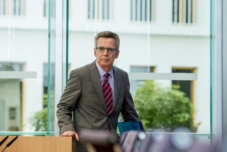 © Reuters. German Interior Minister Thomas de Maiziere  arrives at news conference to present 2013 Crime Report in Berlin