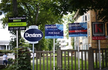 © Reuters. Estate agents boards are lined up outside houses in south London