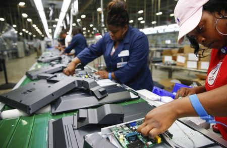 © Reuters. Workers work on installing the motherboard to a 32-inch TV at Element Electronics in Winnsboro