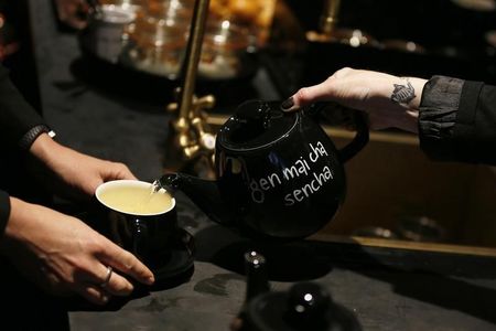 © Reuters. A woman pours tea in a T2 shop in London