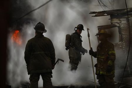 © Reuters. Detroit firefighters try to contain a fire at a shed in Detroit