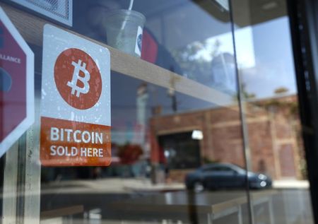 © Reuters. A bitcoin sticker is seen in the window of Locali Conscious Convenience store, where one of Southern California's first two bitcoin-to-cash ATMs began operating today, in Venice