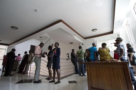 © Reuters. Gay and human rights activists wait outside the courts before filing a constitutional petition against a new anti-homosexuality law, in Kampala