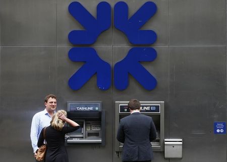 © Reuters. A man uses a cashpoint machine outside a branch of the Royal Bank of Scotland in the City of London