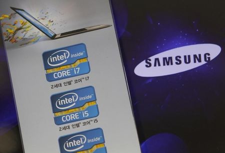 © Reuters. Samsung Electronics' logo is seen on a laptop computer screen in front of an advertisement board promoting Intel processors at a store in Seoul