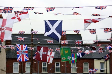 © Reuters. The national flag of Scotland flies amongst other flags in a street in East Belfast