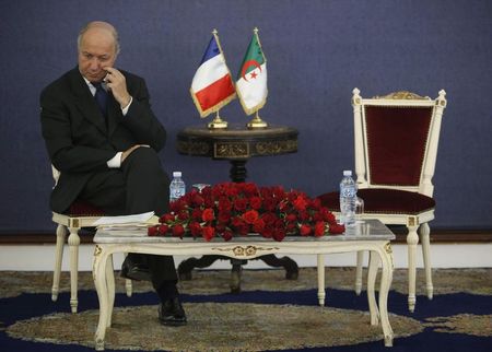 © Reuters. France's Foreign Minister Fabius listens as Algeria's Industry Minister Bouchouareb delivers a speech in Algiers