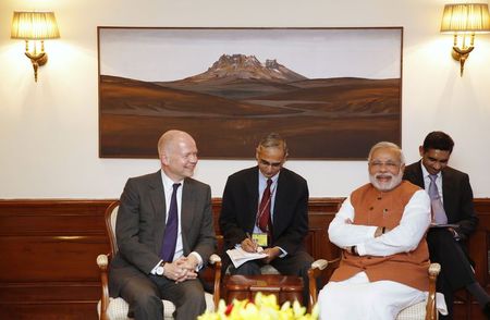 © Reuters. Britain's Foreign Secretary Hague and Indian PM Modi smile during their meeting in New Delhi