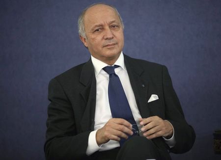 © Reuters. France's Foreign Minister Fabius looks on as he listens to Algeria's Industry Minister Bouchouareb's speech in Algiers