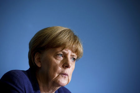 © Reuters. German Chancellor Angela Merkel attends a news conference after a meeting with East German state premiers in Berlin