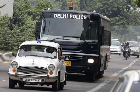 © Reuters. A police bus carrying four men who were found guilty of the fatal gang-rape of a young woman on a bus, arrives at a court in New Delhi