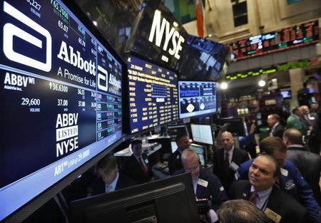 © Reuters. Traders gather at the booth that trades Abbott Laboratories on the floor of the New York Stock Exchange