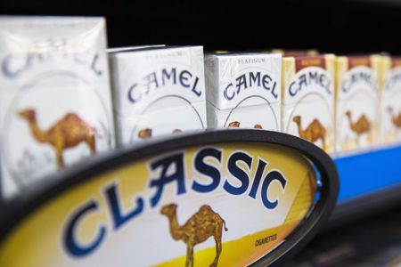 © Reuters. Camel cigarettes are stacked on a shelf inside a tobacco store in New York