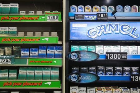 © Reuters. Newport and Camel cigarettes are stacked on a shelf inside a tobacco store in New York