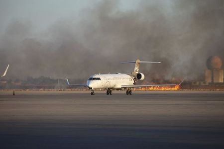© Reuters. Smoke rises after a shelling at Tripoli International Airport July 15, 2014