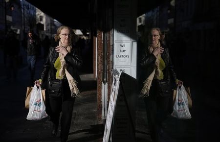 © Reuters. A pedestrian walks along King Street, the main shopping street in Kilmarnock