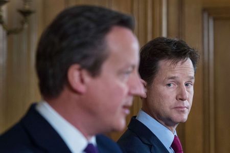 © Reuters. Britain's Deputy Prime Minister Nick Clegg listens to Prime Minister David Cameron speak at a joint news conference at 10 Downing Street in central London