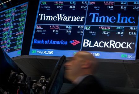 © Reuters. A trader rushes past the post that trades Time Warner stock on the floor of the New York Stock Exchange