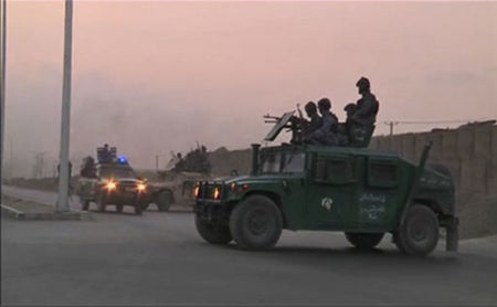© Reuters. Video still shows Afghan security personnel on vehicles as an area near the Kabul airport comes under attack