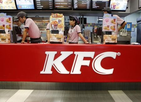 © Reuters. KFC's staff wait for customers at its restaurant in Beijing