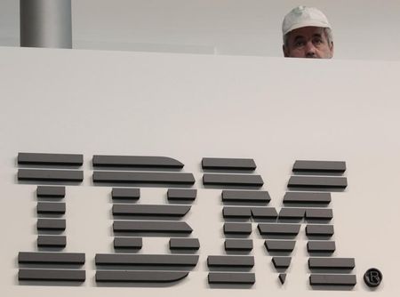 © Reuters. A worker is pictured behind a logo at the IBM stand on the CeBIT computer fair in Hanover