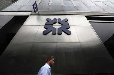 © Reuters. A man passes a branch of Royal Bank of Scotland (RBS) in London