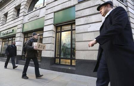© Reuters. Pedestrians walk past a branch of Lloyds bank in central London