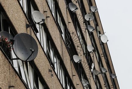 © Reuters. Satellite dishes are seen on the side of a block of flats in south London