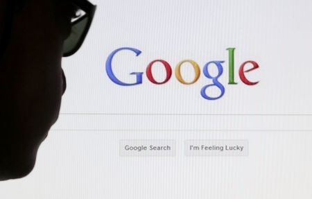 © Reuters. A computer user poses in front of a Google search page in this photo illustration taken in Brussels