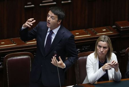 © Reuters. Italian Prime Minister Matteo Renzi delivers his speech as he is flanked by Foreign Minister Federica Mogherini at the Italian Parliament ahead of Italy's European Union presidency in Rome