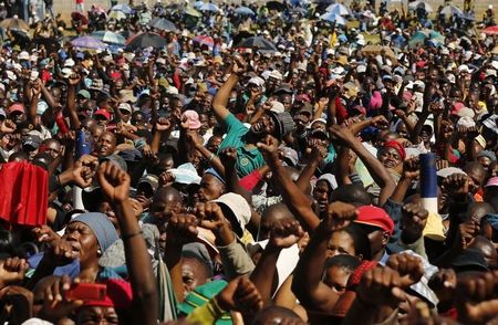 © Reuters. Lonmin workers on strike react as they listen to President of South Africa's AMCU Joseph Mathunjwa at the Wonderkop stadium in Nkaneng township outside the Lonmin mine in Rustenburg