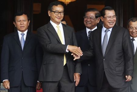 © Reuters. Cambodia's Prime Minister Hun Sen shakes hands with Sam Rainsy, president of the Cambodia National Rescue Party (CNRP), after a meeting at the Senate in central Phnom Penh