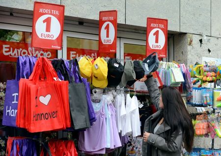 © Reuters. Woman stands in front of a one euro shop in downtown Hanover